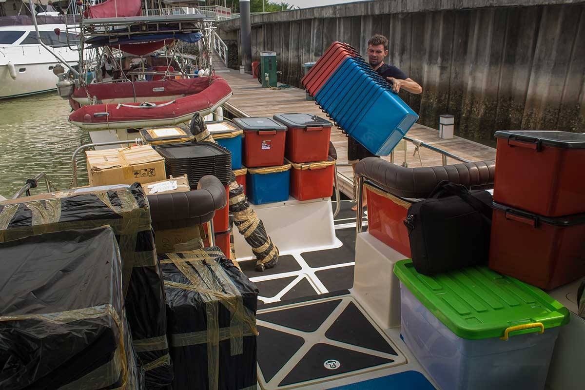 Donated supplies begin to build up on the pier beside Lady Martina.